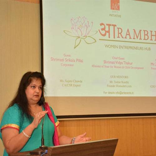Mallikaa speaking at a podium at Aarambh